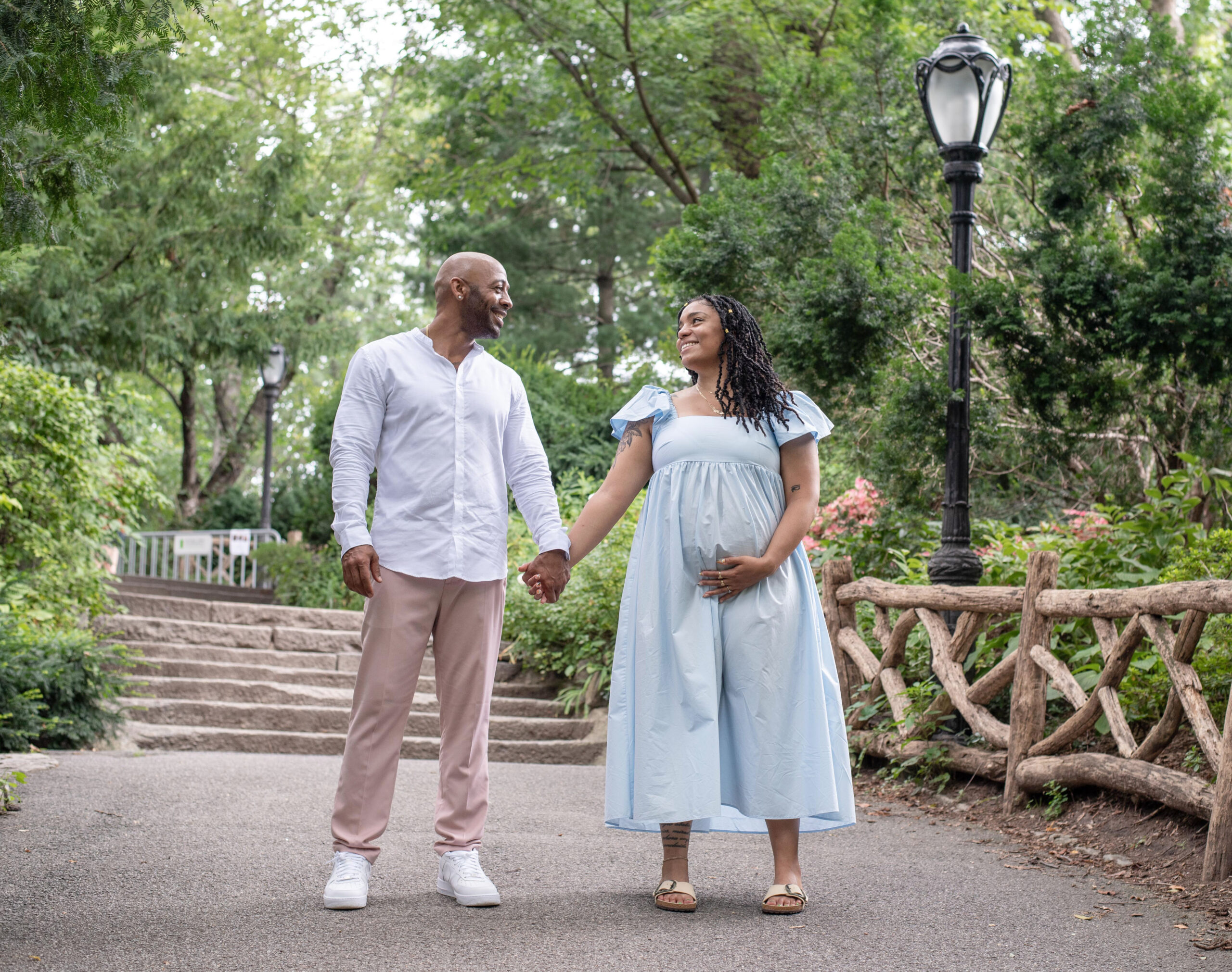 Happy Couple Holding hands During Maternity Photography Session